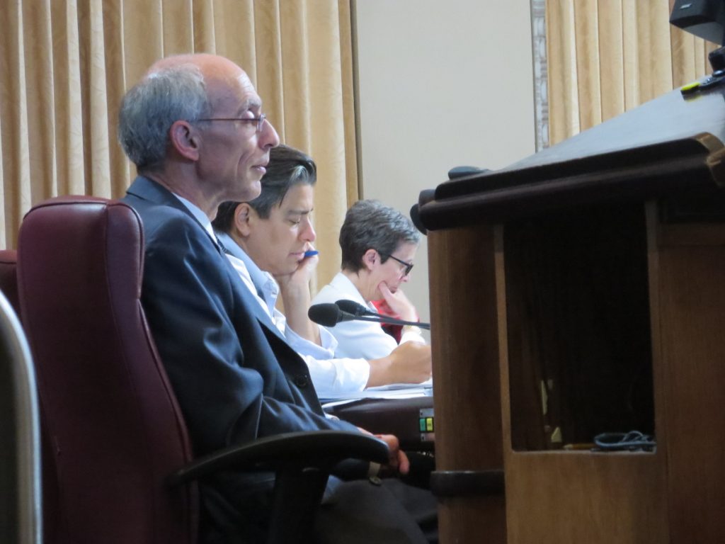 Oakland City Council members Dan Kalb and Rachel Kaplan, and Assistant City Administrator Claudia Cappio, listen to testimony at the City Council meeting, 2016-06-27. Photo credit: Steve Masover.