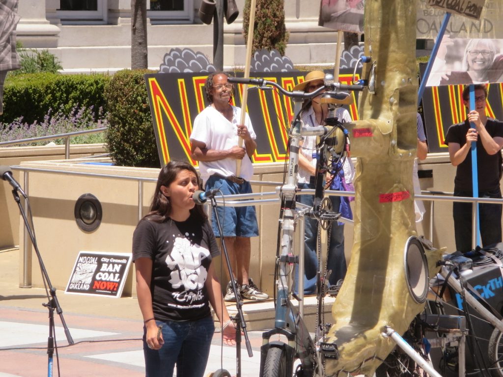 Desirae Harp opening the rally with Native American songs and her own music, at NCIO rally, 2016-06-25. Photo: Steve Masover