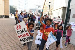 Youth march around Phil Tagami's Rotunda Building demanding the coal developer #DeCOALonize Oakland. Photo credit: Sunshine Velasco from Survival Media Agency