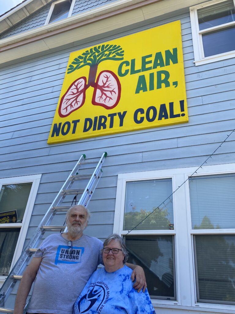 Clean Air, Not Dirty Coal banner mounted at 980 freeway exit.