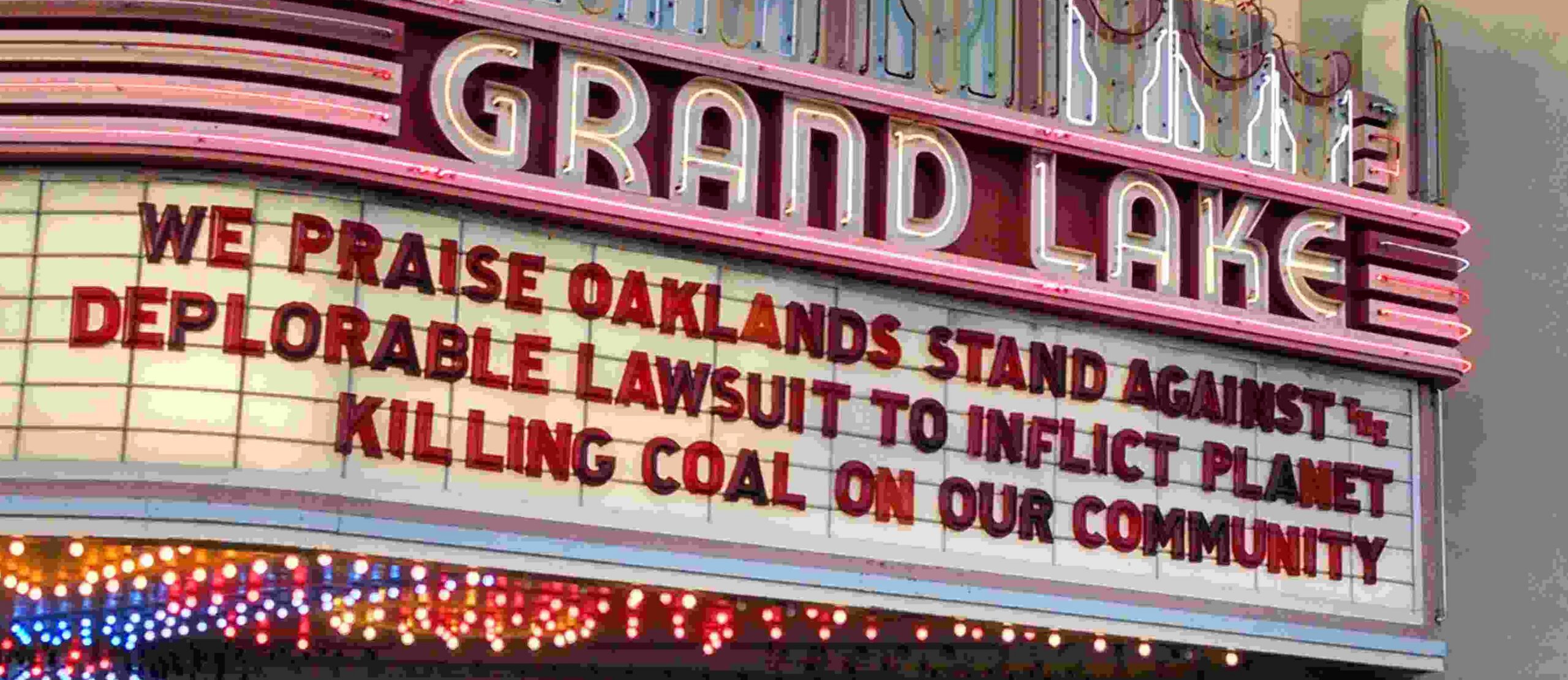 Grand Lake Theater marquee deploring Tagami's lawsuit against the City of Oakland