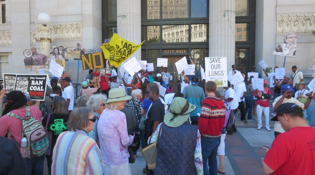 No Coal in Oakland rallies outside City Hall in advance of the special meeting, chanting and drumming in opposition to a crowd of West Oakland residents favoring the 100-200 permanent jobs coal shipment through Oakland would provide over the community's health and safety, 2016-06-27. Photo credit: Steve Masover.