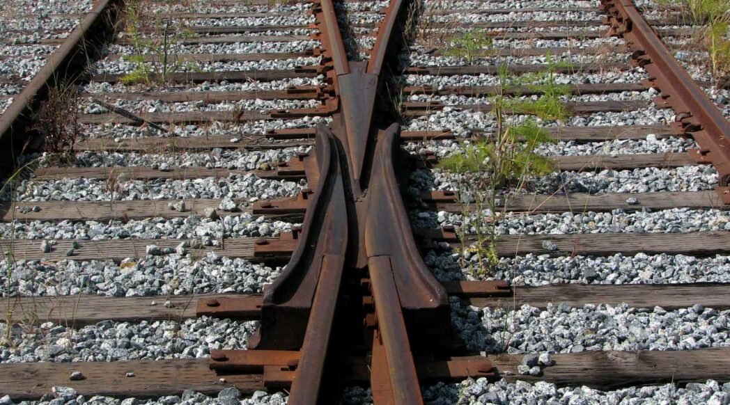 Railroad tracks diverging. Photo credit John Graham (Flickr) Creative Commons license: CC BY-NC-ND 2.0.