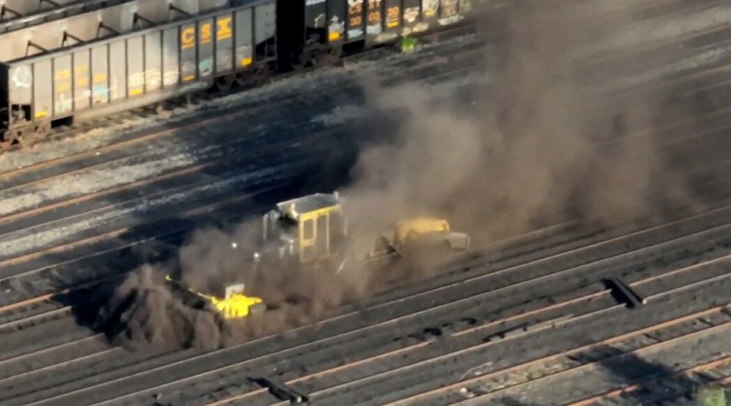 A track maintenance churns up coal dust